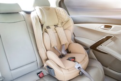 light children's car seat in a bright leather interior