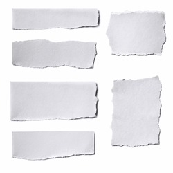 Collection of white paper tears, isolated on white with soft shadows.
