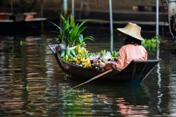 fruit seller sailing boat in dumneon saduak floating market ratchaburi thailand