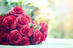 close up beautiful red roses bouquet with glowing light background for valentine day and love theme