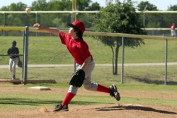 Youth baseball pitcher throwing a pitch