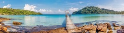 Tropical sea panorama with pier on small island 