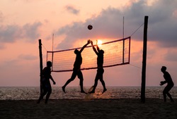 silhouette of beach Volleyball player on the beach and playground sand in sunset