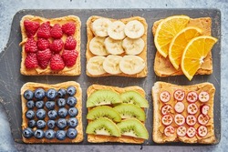 Wholegrain bread slices with peanut butter and various fruits