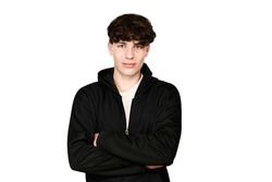 On a white background, a teenage guy with a cute face smiles easily, wearing a white T-shirt and a black sports jacket, the guy is happy, he has good self-esteem and high ambitions