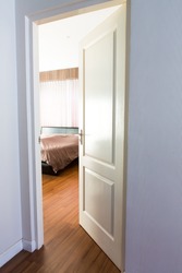 Door opening on a peaceful bedroom