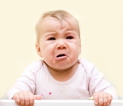 Portrait of crying baby girl.