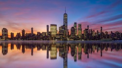 New York City downtown skyline at sunset with beautiful reflection in USA