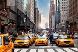 Yellow Taxi in Manhattan, New York City  in USA sunset
