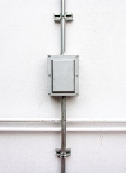 Electric control box on the white wall of factory.