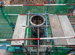 The metal molds for casting the concrete pillar of the overpass bridge near the train station, front view with the copy space.