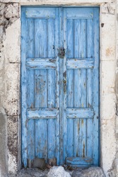 A weathered blue door on the island of Santorini, Greece, Europe