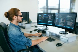 Programming. Man Working On Computer In IT Office, Sitting At Desk Writing Codes. Programmer Typing Data Code, Working On Project In Software Development Company. High Quality Image.
