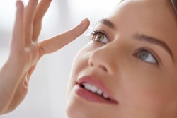 Eye care. Smiling Woman With Contact Lens on Finger Closeup. Smiling Lady with Contact Eye Lenses in Hand. Girl Applying Eye Contacts. Eye Health Care Concept