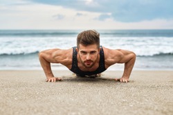 Workout Exercise. Closeup Of Healthy Handsome Active Man With Fit Muscular Body Doing Push Ups Exercises. Sporty Athletic Male Exercising At Beach, Training Outdoor. Sports And Fitness Concept