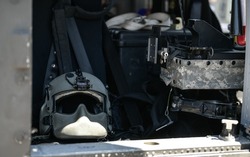 Detail view from inside a United States Airforce helicopter with view of the pilot helmet and cockpit.