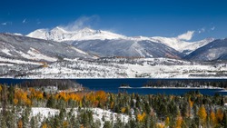 Grays and Torreys Peaks in the Colorado Rocky Mountains with Snow on Aspen Trees and Lake Dillon in the Foreground