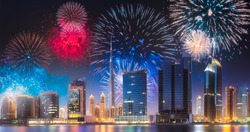 Beautiful fireworks above Dubai Business bay at evening light with reflection on water, UAE