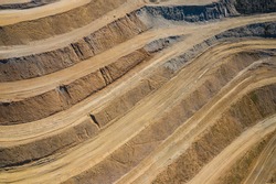 Aerial view of industrial terraces on mineral mine. Opencast mining. Drone view from above.