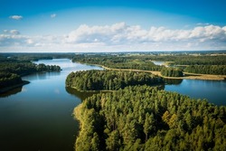 Masuria. Aerial view of green islands and clouds at summer sunny day. Masurian Lake District in Poland. 