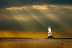 lighthouse at talacre, north wales, uk in the afterglow following a storm at sea