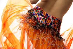 Belly of the woman dancing in the orange dancing dress
