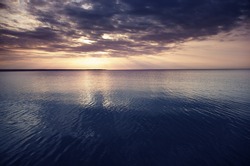 Sunset at the sea. Horizontal photo with natural light and darkness