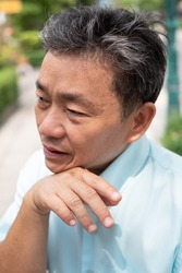 old man sweating due to hot weather, heatstroke, strong uv light or sunburn