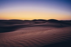 Sand dunes against sky before sunrise. Desert Wahiba Sands in Oman.