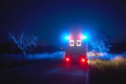 Ambulance car of emergency medical service on road at night. Themes rescue, urgency and health care. 