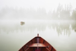Boats on the lake at morning fog.