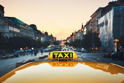 Taxi car on the city street at dusk.  Wenceslas Square, Prague, Czech Republic