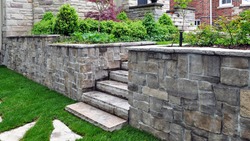 Natural stone steps and retaining wall in the garden.