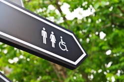 Men and women toilet sign with an arrow showing direction