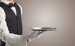 Waiter serving with white gloves and steel tray in an empty space
