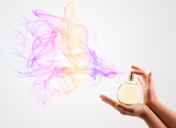 close up of woman hands spraying perfume