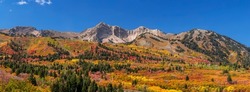 Panoramic view of Snow basin landscape with bright fall foliage around Mont Ogden in Utah