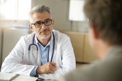 Doctor talking to patient in office