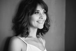 Black and white portrait of an excited beautiful woman