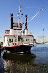 A stearn-wheeled paddle boat offers cruises of the Inner Harbor, Baltimore, MD