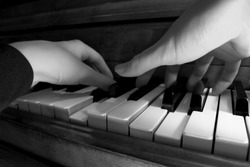 Two hands playing the piano - shallow focus