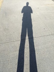 distorted human shadow on a sunny day