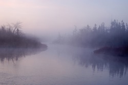 A river on a foggy morning at sunrise