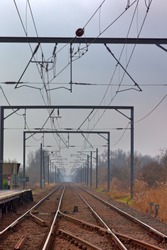 Overhead electricty supply for the tains on the London to Kings Lynn line in Cambridgeshire, England, UK.