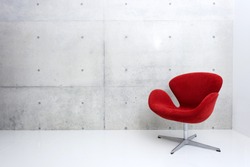 modern red chair and concrete wall