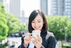 Young business woman holding a smart phone