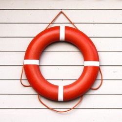 life belt, rescue ring on wooden wall