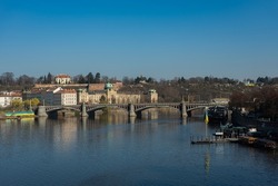 Prague, Czech Republic view of the Vltava river on the Manes bridge. The end of March. River banks in Ukrainian flags. The Czech Republic supports Ukraine in the war, Russian aggression.
