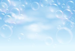 Realistic soap bubbles flying on the blue background with clouds. Vector illustration.