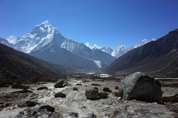Everest trek, Huge boulder on the way down from Dughla to Pheriche with view of Ama Dablam mountain. Himalayas, Nepal